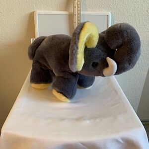 Sugar loaf gray plush elephant with yellow ears.